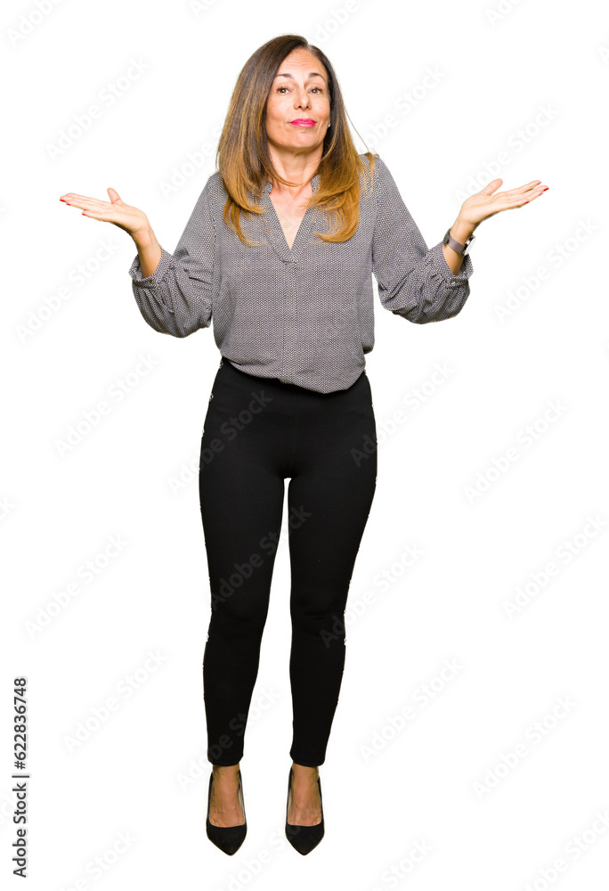 Beautiful middle age business woman clueless and confused expression with arms and hands raised. Doubt concept. Beautiful middle age business woman clueless and confused expression with arms and hands raised. Doubt concept.