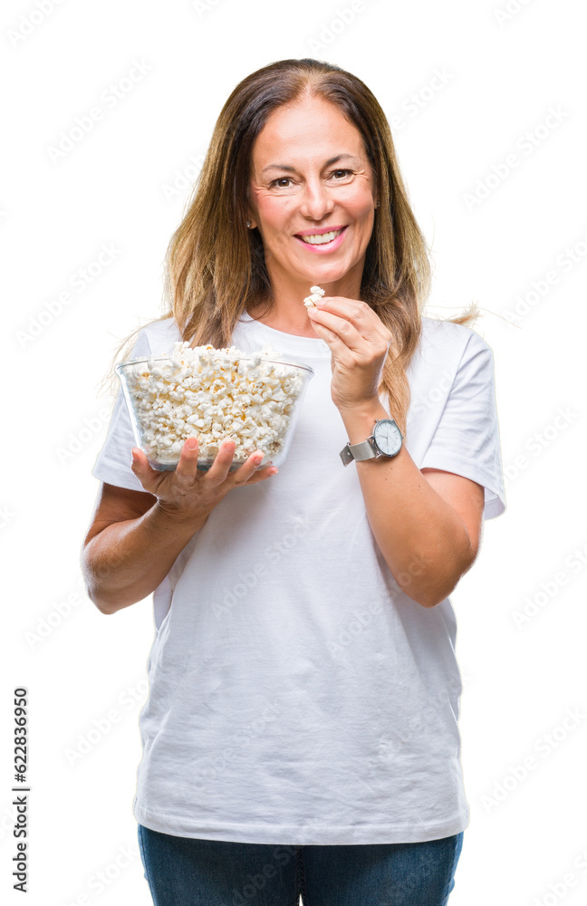 Middle age hispanic woman eating popcorn over isolated background with a happy face standing and smiling with a confident smile showing teeth Middle age hispanic woman eating popcorn over isolated background with a happy face standing and smiling with a confident smile showing teeth