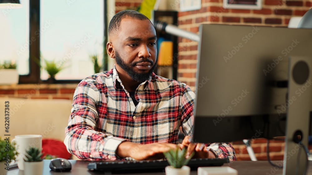 Employee concentrating on finishing up important job tasks, remotely working from stylish apartment personal office. Focued teleworker typing on computer keyboard, close up Employee concentrating on finishing up important job tasks, remotely working from stylish apartment personal office. Focued teleworker typing on computer keyboard, close up
