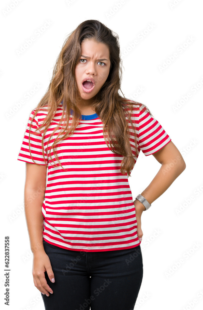Young beautiful brunette woman wearing stripes t-shirt over isolated background In shock face, looking skeptical and sarcastic, surprised with open mouth Young beautiful brunette woman wearing stripes t-shirt over isolated background In shock face, looking skeptical and sarcastic, surprised with open mouth