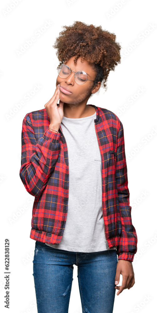 Beautiful young african american woman wearing glasses over isolated background touching mouth with hand with painful expression because of toothache or dental illness on teeth. Dentist concept.