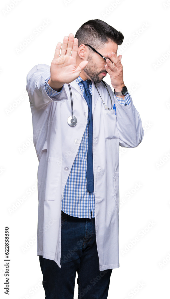 Handsome young doctor man over isolated background covering eyes with hands and doing stop gesture with sad and fear expression. Embarrassed and negative concept. Handsome young doctor man over isolated background covering eyes with hands and doing stop gesture with sad and fear expression. Embarrassed and negative concept.