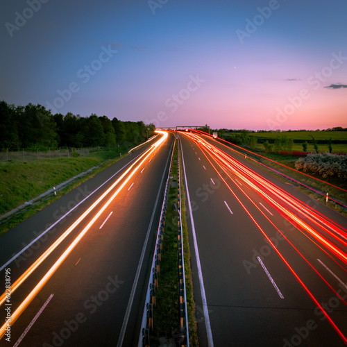 Long Exposure photography of cars on road at sunset