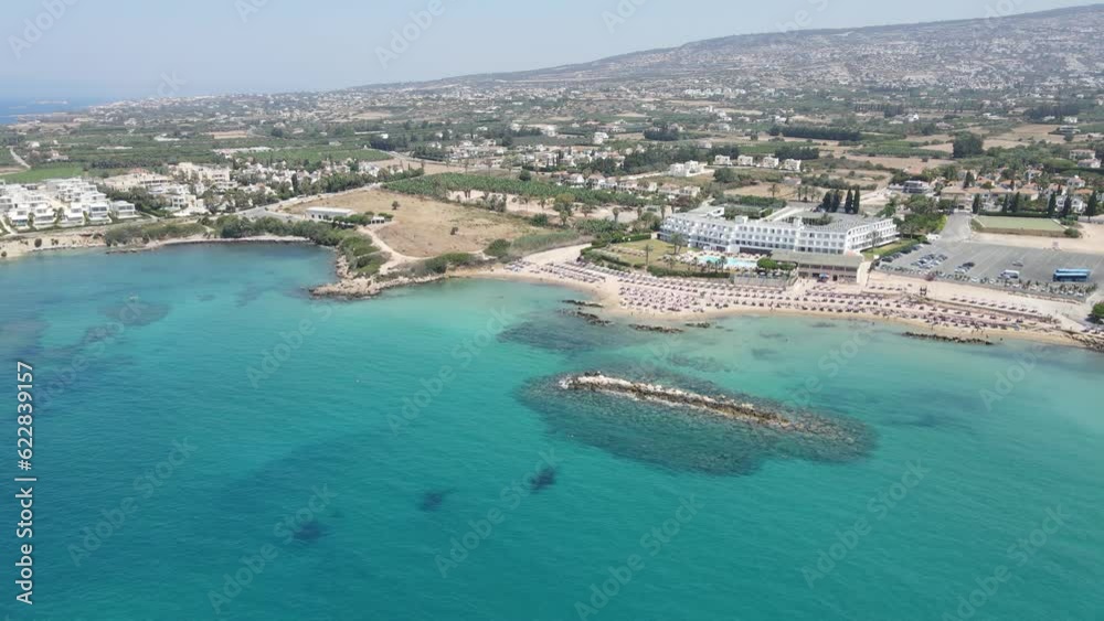 Corallia Beach on the island of Cyprus, located in the town of Peja near Paphos. A bird's-eye view captures the stunning, pristine blue waters of the Mediterranean Sea. Corallia Beach on the island of Cyprus, located in the town of Peja near Paphos. A bird's-eye view captures the stunning, pristine blue waters of the Mediterranean Sea.
