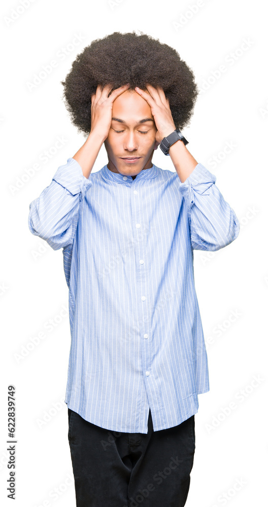 Young african american man with afro hair suffering from headache desperate and stressed because pain and migraine. Hands on head. Young african american man with afro hair suffering from headache desperate and stressed because pain and migraine. Hands on head.