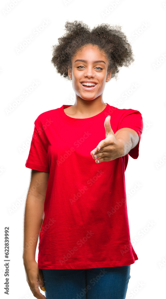 Young afro american woman over isolated background smiling friendly offering handshake as greeting and welcoming. Successful business. Young afro american woman over isolated background smiling friendly offering handshake as greeting and welcoming. Successful business.