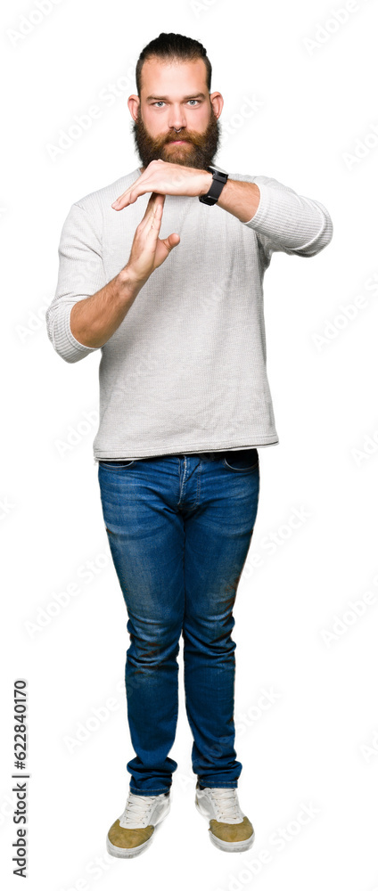 Young blond man wearing casual sweater Doing time out gesture with hands, frustrated and serious face Young blond man wearing casual sweater Doing time out gesture with hands, frustrated and serious face