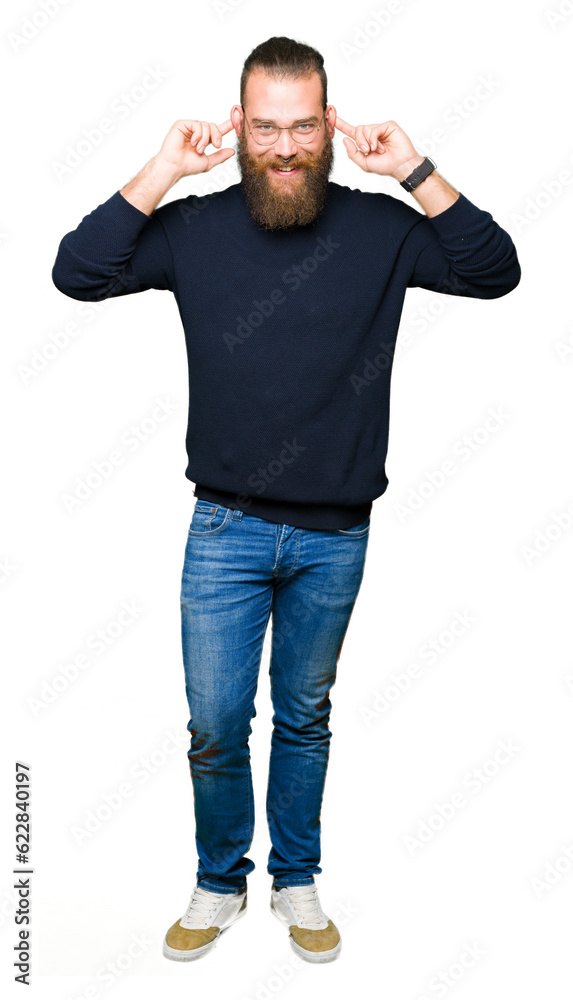 Young blond man wearing glasses and turtleneck sweater Smiling pulling ears with fingers, funny gesture. Audition problem Young blond man wearing glasses and turtleneck sweater Smiling pulling ears with fingers, funny gesture. Audition problem