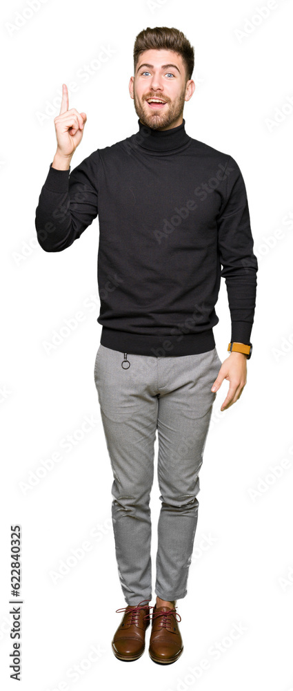 Young handsome blond man wearing winter sweater pointing finger up with successful idea. Exited and happy. Number one. Young handsome blond man wearing winter sweater pointing finger up with successful idea. Exited and happy. Number one.
