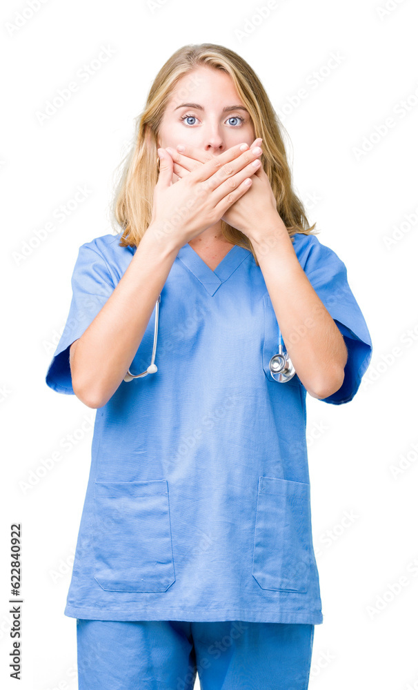 Beautiful young doctor woman wearing medical uniform over isolated background shocked covering mouth with hands for mistake. Secret concept.