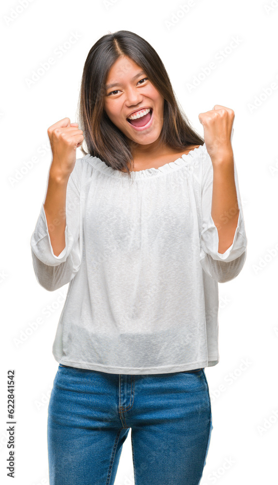 Young asian woman over isolated background very happy and excited doing winner gesture with arms raised, smiling and screaming for success. Celebration concept. Young asian woman over isolated background very happy and excited doing winner gesture with arms raised, smiling and screaming for success. Celebration concept.