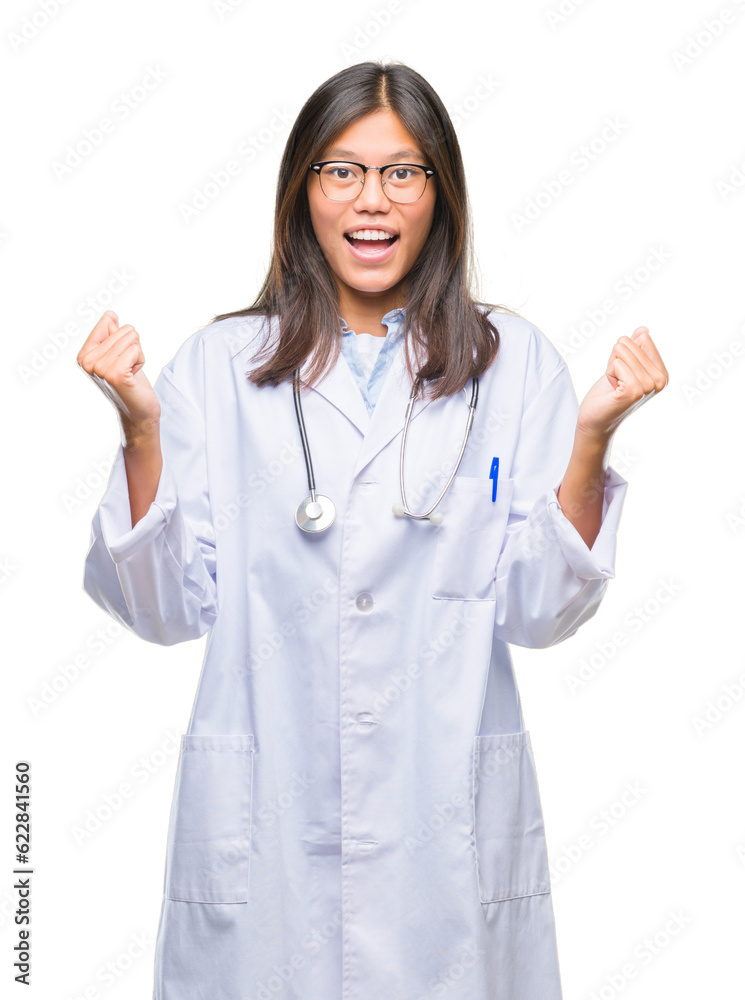 Young asian doctor woman over isolated background celebrating surprised and amazed for success with arms raised and open eyes. Winner concept. Young asian doctor woman over isolated background celebrating surprised and amazed for success with arms raised and open eyes. Winner concept.