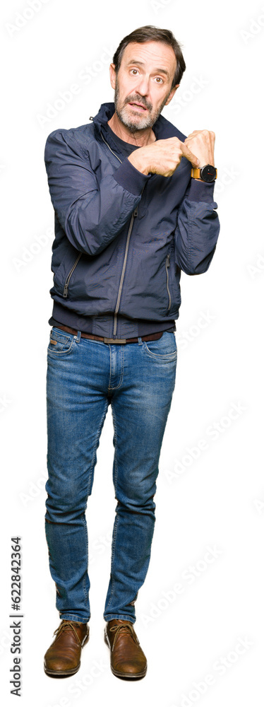 Middle age handsome man wearing a jacket In hurry pointing to watch time, impatience, upset and angry for deadline delay Middle age handsome man wearing a jacket In hurry pointing to watch time, impatience, upset and angry for deadline delay