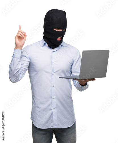 Business hacker man holding a computer laptop surprised with an idea or question pointing finger with happy face, number one