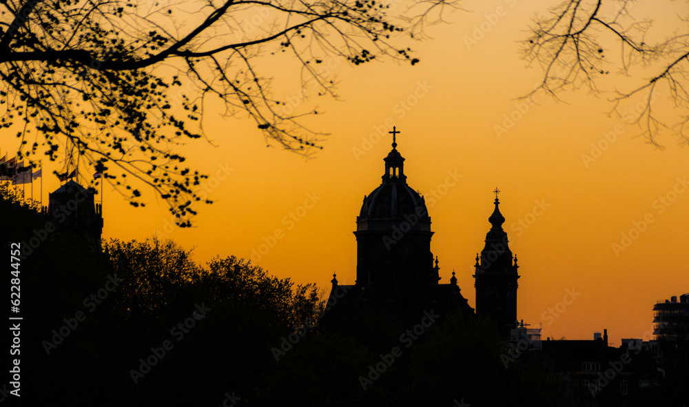Oudekerk silhouette at sunset in Amsterdam, Netherlands