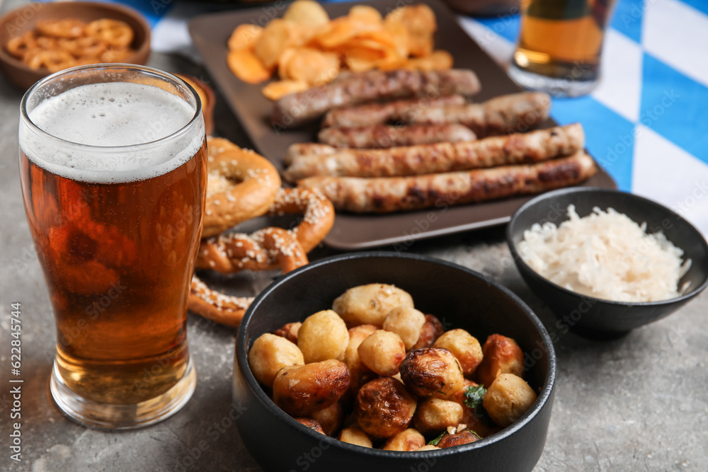 Glass of cold beer and fried potato on grunge background. Oktoberfest celebration Glass of cold beer and fried potato on grunge background. Oktoberfest celebration