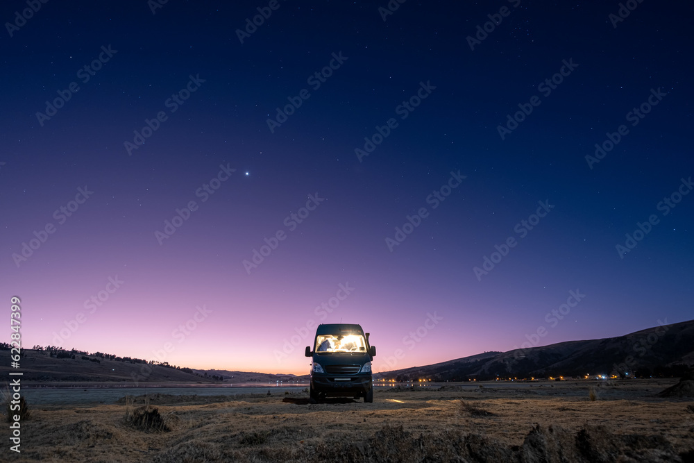 Campervan facing the blue hour with the last gleams of sunshine