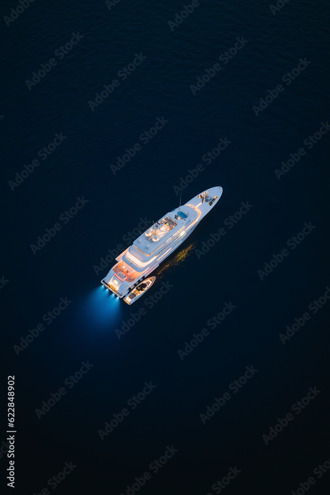 Aerial view of a yacht in Positano at night, Amalfi Coast, Italy. Aerial view of a yacht in Positano at night, Amalfi Coast, Italy.