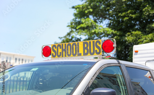 yellow school bus parked in front of a school, representing education, childhood, transportation, and community