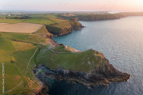 Aerial view of Port Quin Bay and Doyden Castle at sunset, Cornwall, United Kingdom. photo