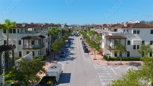 Aerial view of beautiful new contemporary suburban townhouses in american neighborhood on busy street with lots of cars. Brand new houses on real estate market of Miami photo