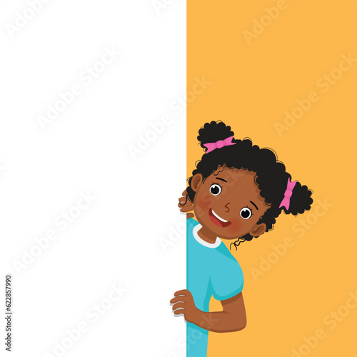 Little African girl standing behind blank board peeking empty banner with finger