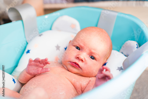 A newborn baby takes a bath. A lovely child is undergoing military training for the first time. The concept of children and hygiene