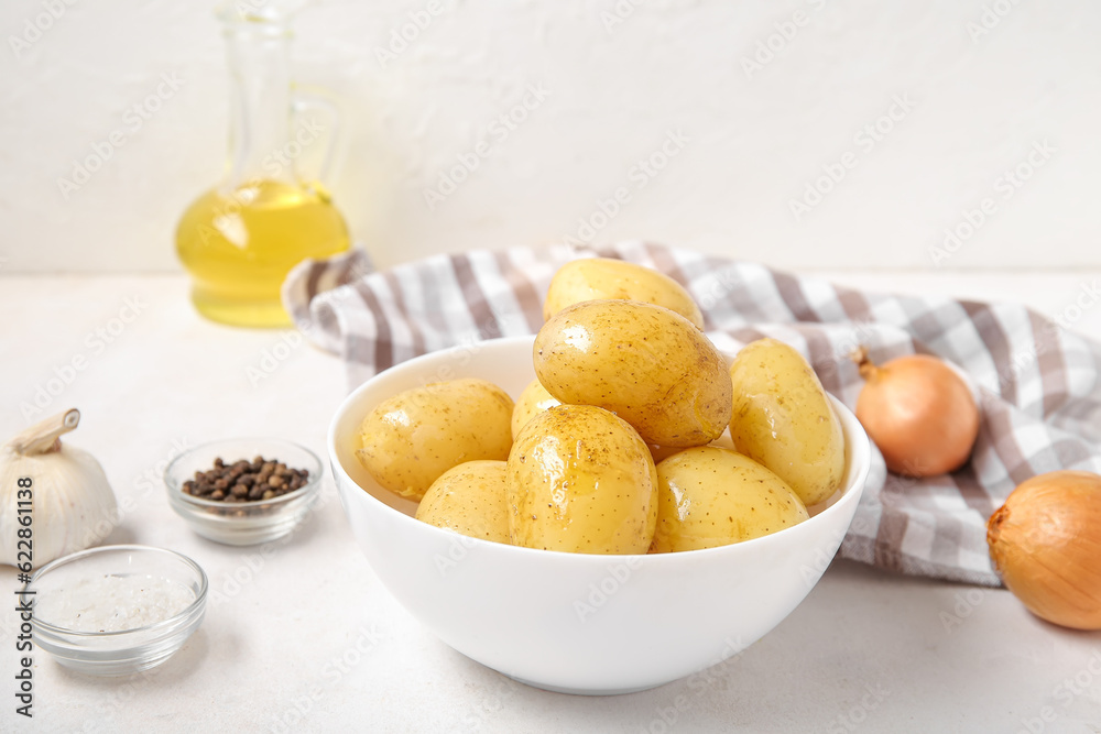 Bowl with raw potatoes on light background Bowl with raw potatoes on light background