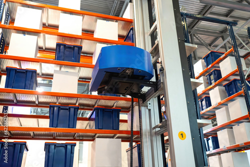 Warehouse robot near shelve...