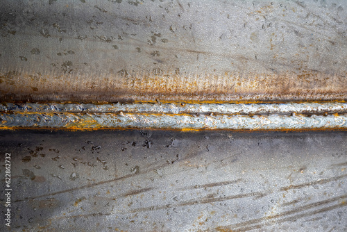 Seam on metal surface. Trac...
