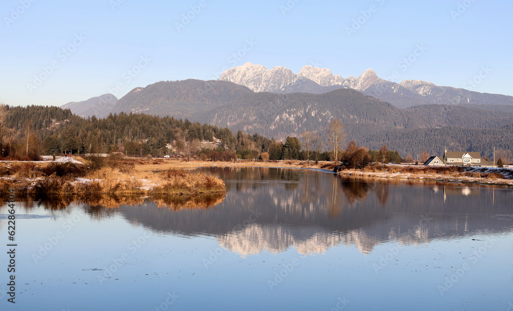 Winter panorama with reflection of snowy mountains