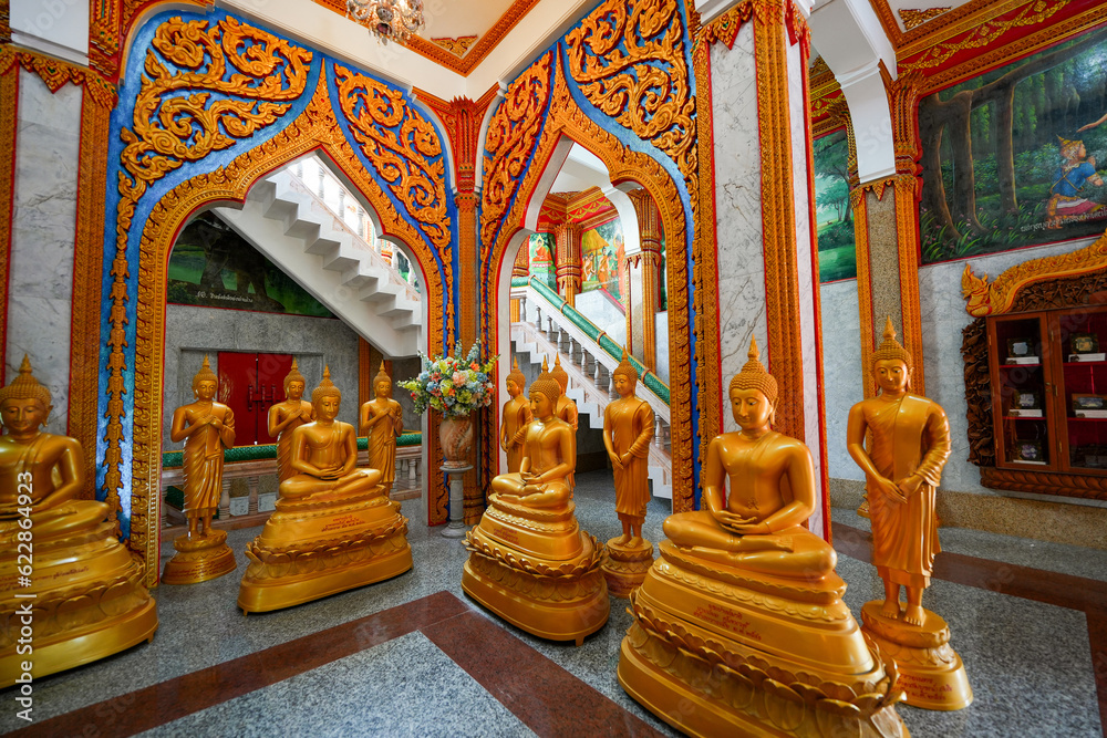 Buddha golden statues in the chedi (pagoda) of the Wat Chalong, a 19th century Buddhist temple on Phuket island in Thailand, Southeast Asia