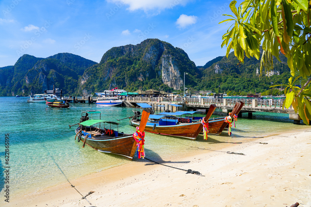 Fototapeta premium Longtail boats moored on Ton Sai beach on Koh Phi Phi island in the Andaman Sea, Krabi Province, Thailand