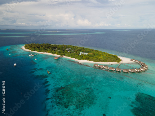 Maldives - 01 May 2023: Aerial view of tropical island with water villa, Baa Atoll, Maldives. photo