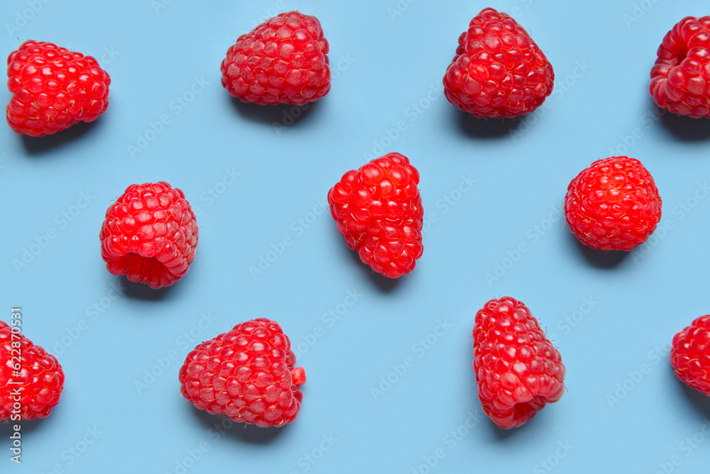 Many fresh raspberries on blue background Many fresh raspberries on blue background