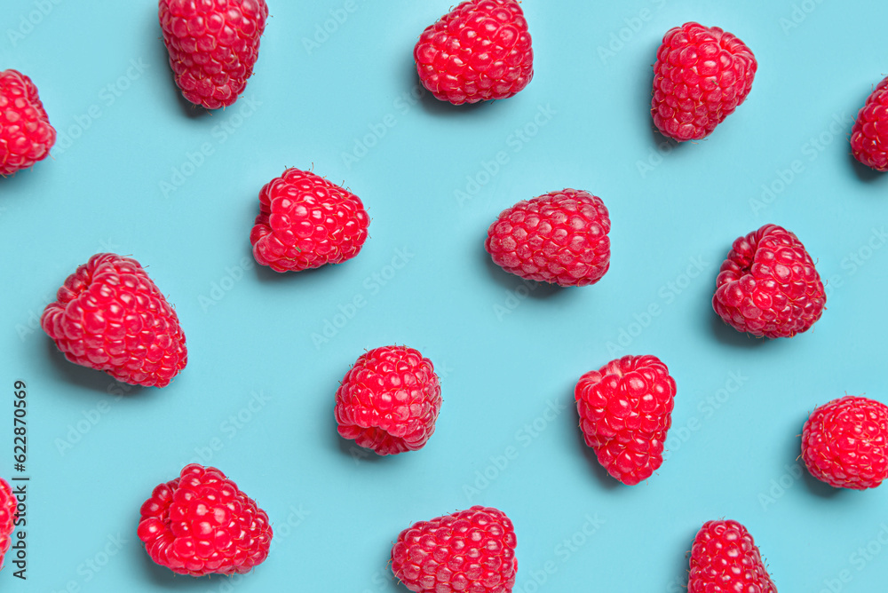 Many fresh raspberries on blue background Many fresh raspberries on blue background