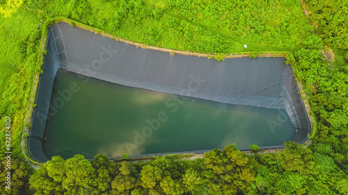 a Leachate pond with synthetic lining and surrounding fence photo