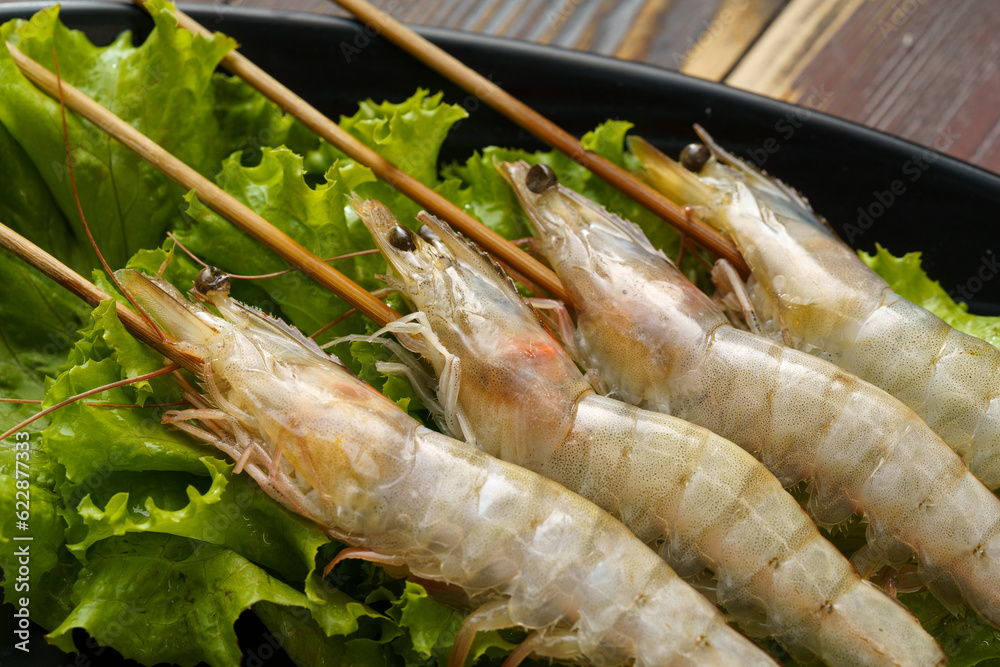 Fresh shrimp skewers on a monochrome background Fresh shrimp skewers on a monochrome background