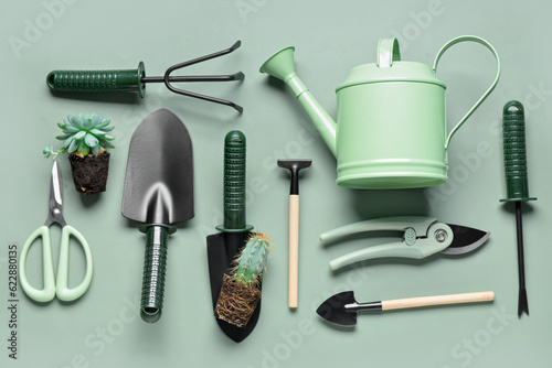 Set of gardening tools on green background