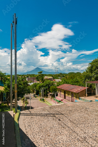 Streets of Nagarote with a view of the momotombo volcano on a beautiful day. View of the Momotombo volcano, from Nagarote photo