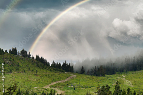 rainbow over the mountains at snoqualmie pass