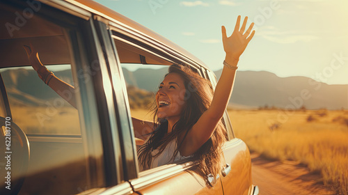 Happy woman waving hand outside open window car with meadow and mountain background. Female lifestyle relaxing as traveler on road trip in holiday vacation. Transportation and travel
