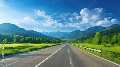Green mountain and empty asphalt highway natural scenery under the blue sky