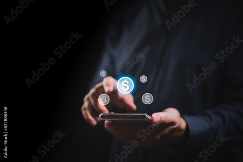 Businessman hand holding smartphone and dollar icon floating in the air, business volatility concept, growth market in value with inflation and financial crisis