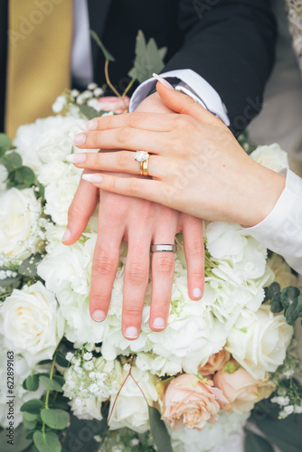 Close Up of Bride holding groom hand with Wedding Rings and White Flowers – Muslim Wedding, Marriage Ceremony, Love, Romance, Commitment, Engagement, Bridal Jewelry, Islamic Culture, Marriage