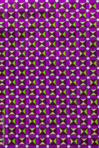top view of purple and green ankara fabric, flatlay of nigerian wax purple and green ankara material on a table photo