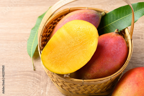Mango fruit (Palmer mango) in basket on wooden background, Tropical fruit