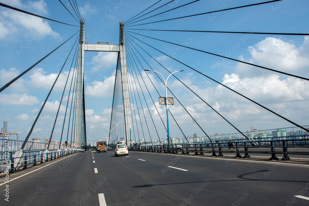 9th July, 2023, Kolkata, West Bengal, India: POV of a bike rider of morning traffic movement on Bidyasagar Setu or Second Hoogly bridge at Kolkata.