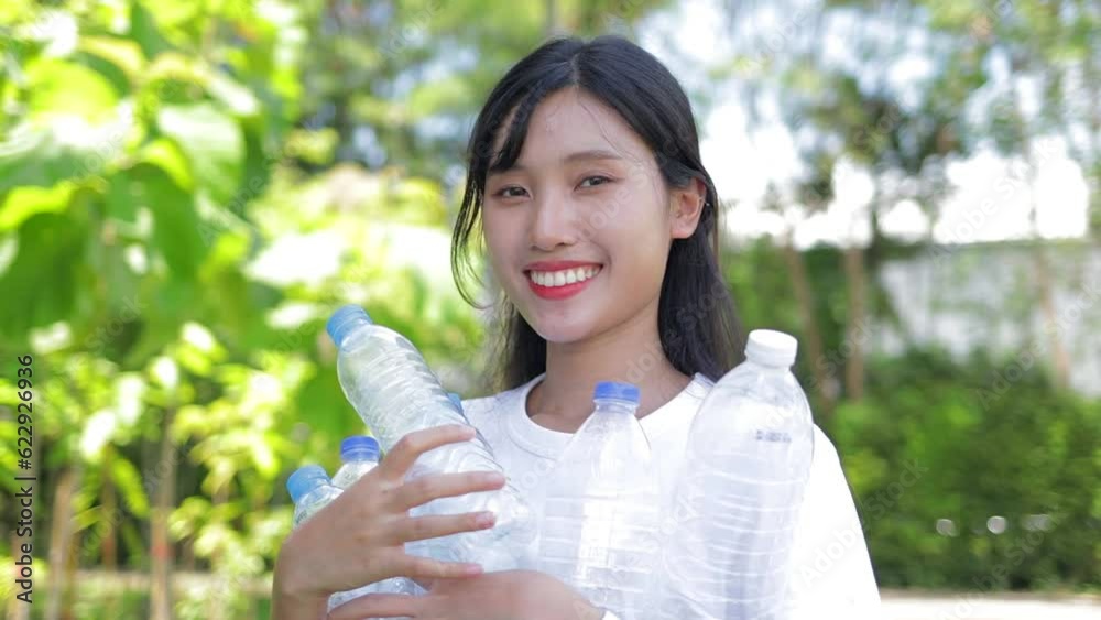 Asian volunteer women pick up plastic bottles to keep them clean. Social volunteer concept, world environment day Asian volunteer women pick up plastic bottles to keep them clean. Social volunteer concept, world environment day