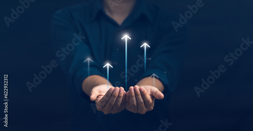Tela Hand holding growth business strategy arrow concept on success target improvement with increase development graph profit or economy investment income target and goal increase achievement